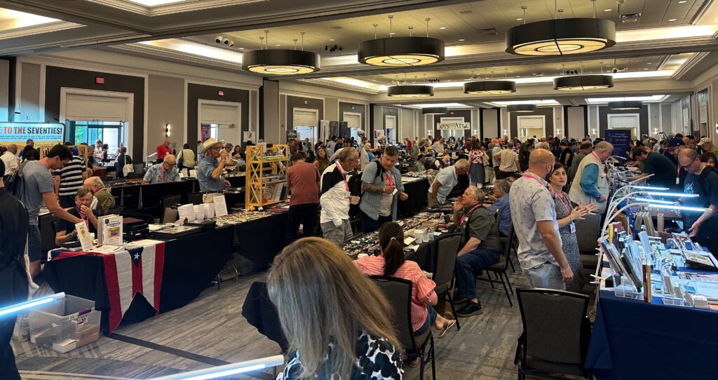 Fountain pens on display at a pen show vendor tables
